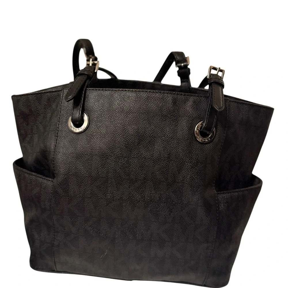 Michael Kors Elegant Black Handbag. Sides packets with a log in the front